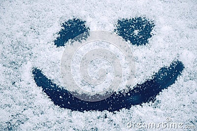 Happy smiley emoticon face in snow Stock Photo