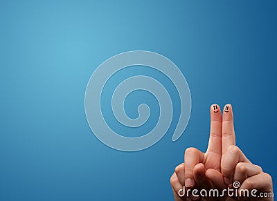 Happy smiley face fingers looking at empty blue background copy Stock Photo