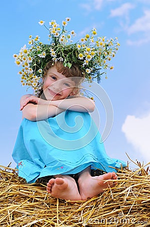 Happy smiley girl with camomile wreath Stock Photo