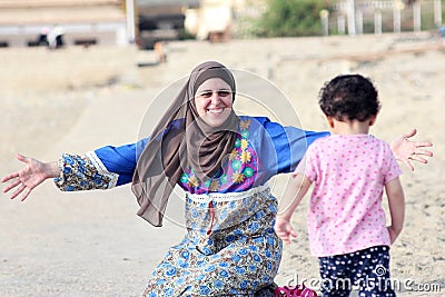 Happy smiling arab muslim mother hug her baby girl in egypt Stock Photo