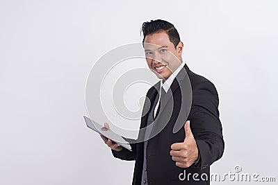 Happy smiling Asian businessman with thumbs up gesture looking at camera Stock Photo