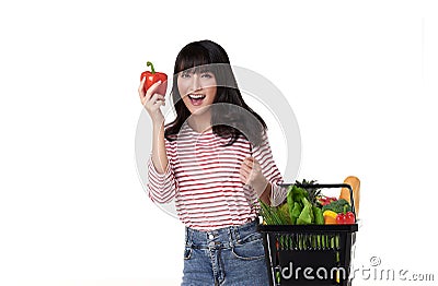 Happy smiling Asian woman holding basket shopping full of vegetables isolated on white background Stock Photo