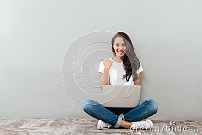 Happy smiling asian woman working on laptop computer Stock Photo