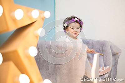 Happy smiling sweet baby girl sitting on armchair with shining light star, Birthday girl, One year old Stock Photo