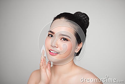 Happy smiling beautiful asian woman using cotton pad cleaning sk Stock Photo