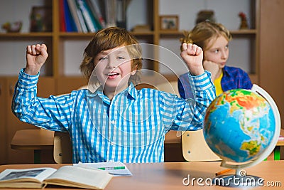 Happy smiling boy on the geography lesson in school classroom. Educational concept Stock Photo