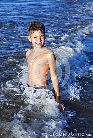 Happy smiling boy in the waves of the Baltic Sea Stock Photo