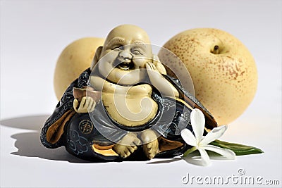 Happy smiling Buddha with two asian pears Stock Photo