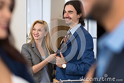 Happy Smiling Business Man Try New Suit With Young Female Seller Helping Stock Photo