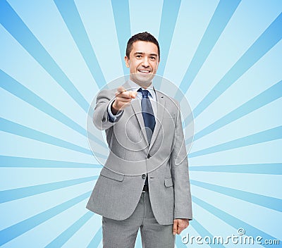 Happy smiling businessman in suit pointing at you Stock Photo