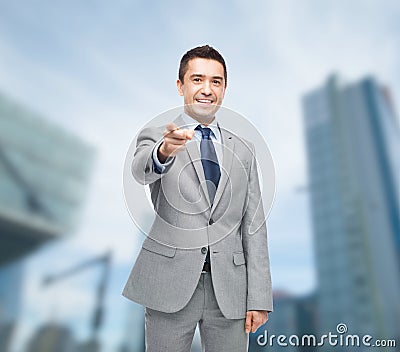 Happy smiling businessman in suit pointing at you Stock Photo