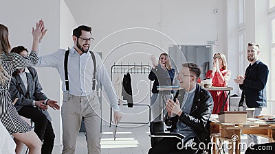 Happy smiling Caucasian manager man entering office celebrating success with team cheering him up slow motion RED EPIC. Stock Photo