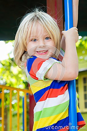 Happy, smiling child playing in a play ground Stock Photo