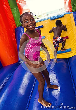 Happy smiling children playing on an inflatable bounce house Stock Photo