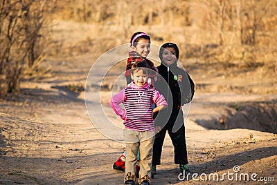 Happy smiling children walking about the country road. Tajikistan. Dushanbe. 11.12.2010 Editorial Stock Photo