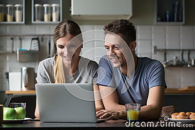 Happy smiling couple looking at laptop screen together Stock Photo