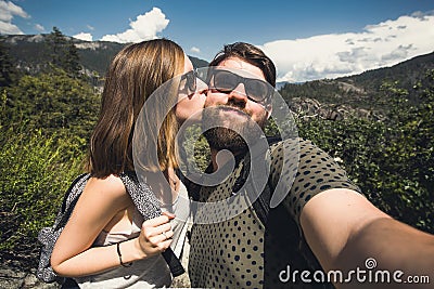 Happy smiling couple of students in love take selfie self-portrait while hiking in Yosemite National Park, California Stock Photo