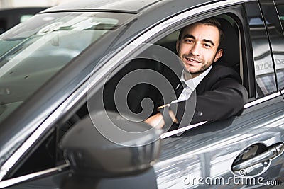 Happy smiling driver in the car, portrait of young successful business man Stock Photo