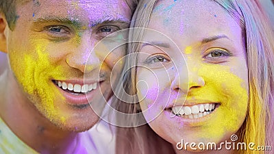 Happy smiling faces, joyful young people looking camera closeup, color festival Stock Photo