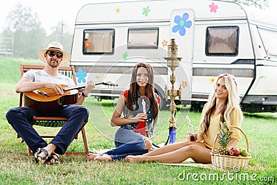 Happy, smiling friends having a picnic outdoors. Stock Photo