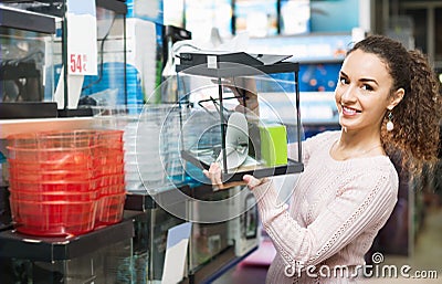 Happy smiling girl choosing domestic aquarium Stock Photo