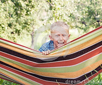 Happy smiling little boy portrait in hammock Stock Photo