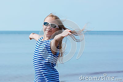 Happy smiling little girl in sunglasses on beach vacation Stock Photo