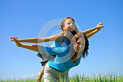 Happy smiling Mother and the daughter fly in sky Stock Photo