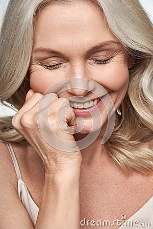 Happy cute shy middle aged woman laughing. Anti age face skin care, closeup view Stock Photo
