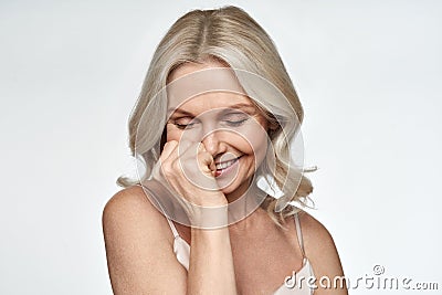 Happy cute shy middle aged woman laughing. Anti age face skin care, portrait. Stock Photo