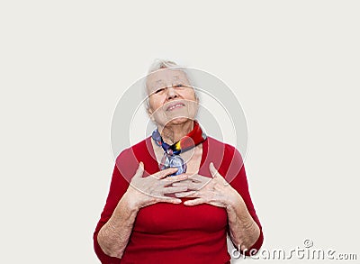 Happy smiling retired senior woman looking at camera isolated on white background Stock Photo