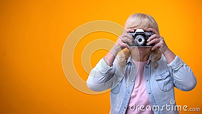 Happy smiling retiree woman taking photo, hobby and relaxation, leisure time Stock Photo