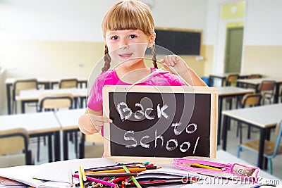 Happy smiling schoolchild holding small blackboard Stock Photo