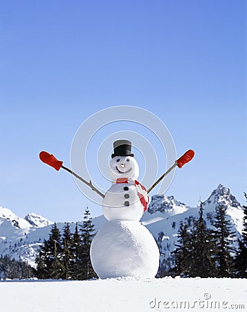 Happy, smiling snowman with mountains in background Stock Photo
