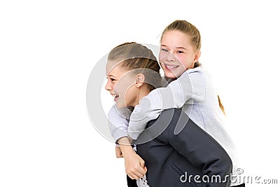 Happy Smiling Teen Girl Piggy Backing her Twin Sister Stock Photo