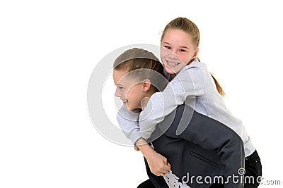 Happy Smiling Teen Girl Piggy Backing her Twin Sister Stock Photo