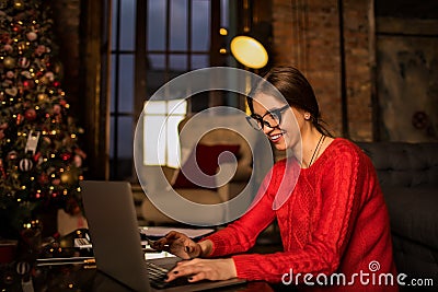 Happy smiling woman in fashionable glasses and casual wear skilled content writer typing text on laptop computer Stock Photo