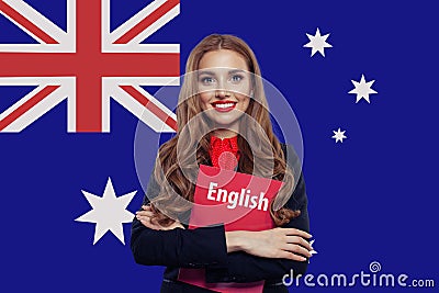 Happy smiling woman student with book against australian flag background. Travel and education in Australia Stock Photo