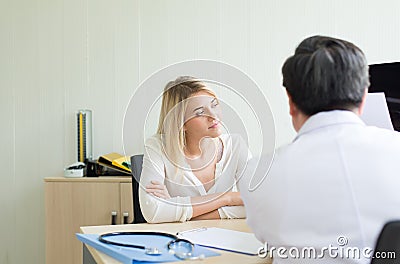Happy and smiling woman talking to doctor psychiatrist in hospital,Discuss issue and find solutions to mental health problems Stock Photo