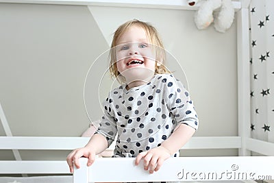 Happy smiling 2 years little girl in her bed at home Stock Photo