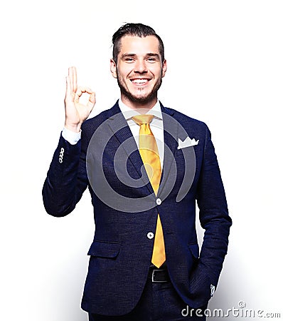 Happy smiling young business man with thumbs up gesture Stock Photo