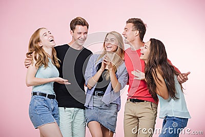Happy smiling young group of friends standing together talking and laughing. Best friends Stock Photo