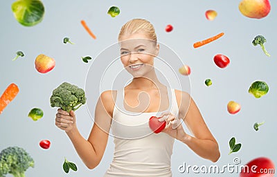 Happy smiling young woman with heart and broccoli Stock Photo