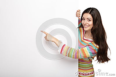 Happy smiling young woman showing blank signboard. Stock Photo