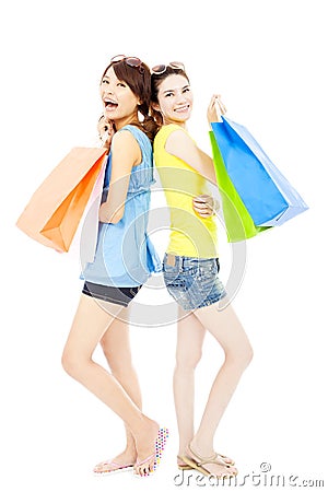 Happy and smiling young women with shopping bags Stock Photo