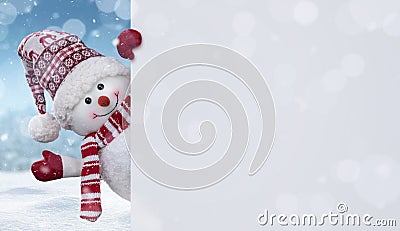 Happy snowman behind the blank banner with copy space Stock Photo