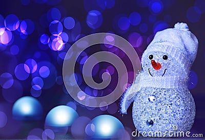 Happy snowman standing in winter with bokeh light Stock Photo