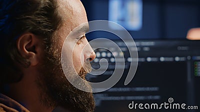 Joyous IT admin looking at PC screen, pleased after solving script errors Stock Photo