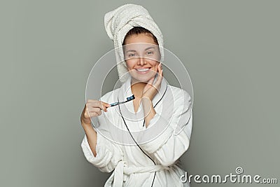 Happy spa woman with cute smile, white teeth, toothbrush and toothpaste on white Stock Photo