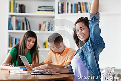 Happy spanish female student with group of learning students Stock Photo